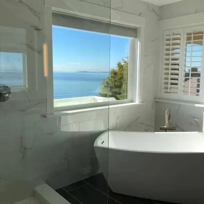 Bathroom with ocean view window and tub