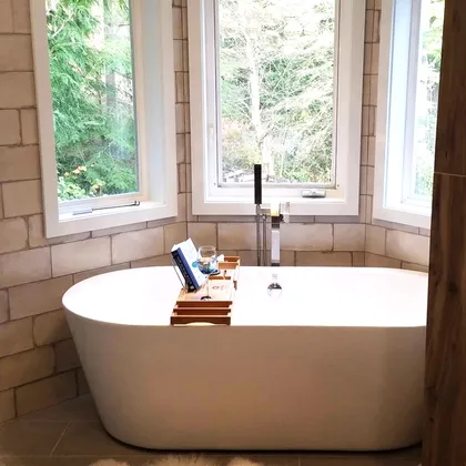 Bathroom with standalone tub and window view