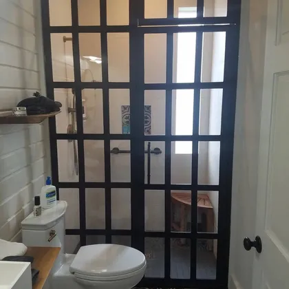 Powder room with dark framed glass door