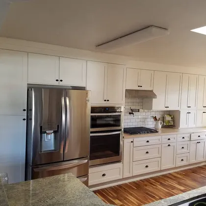 White kitchen with stainless appliances