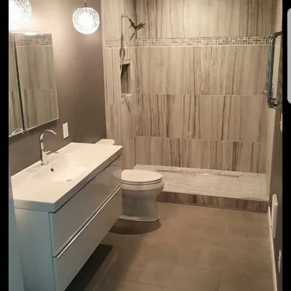 Bathroom with floating vanity and tile walls