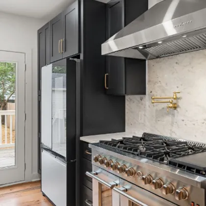 Kitchen with dark cabinets and gas range