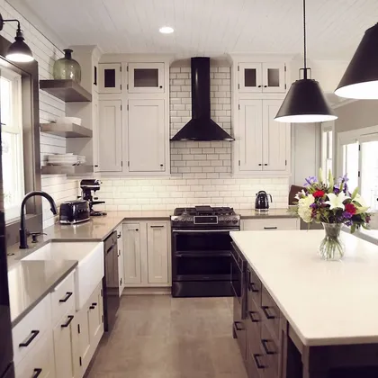 Cozy kitchen with black and white cabinetry